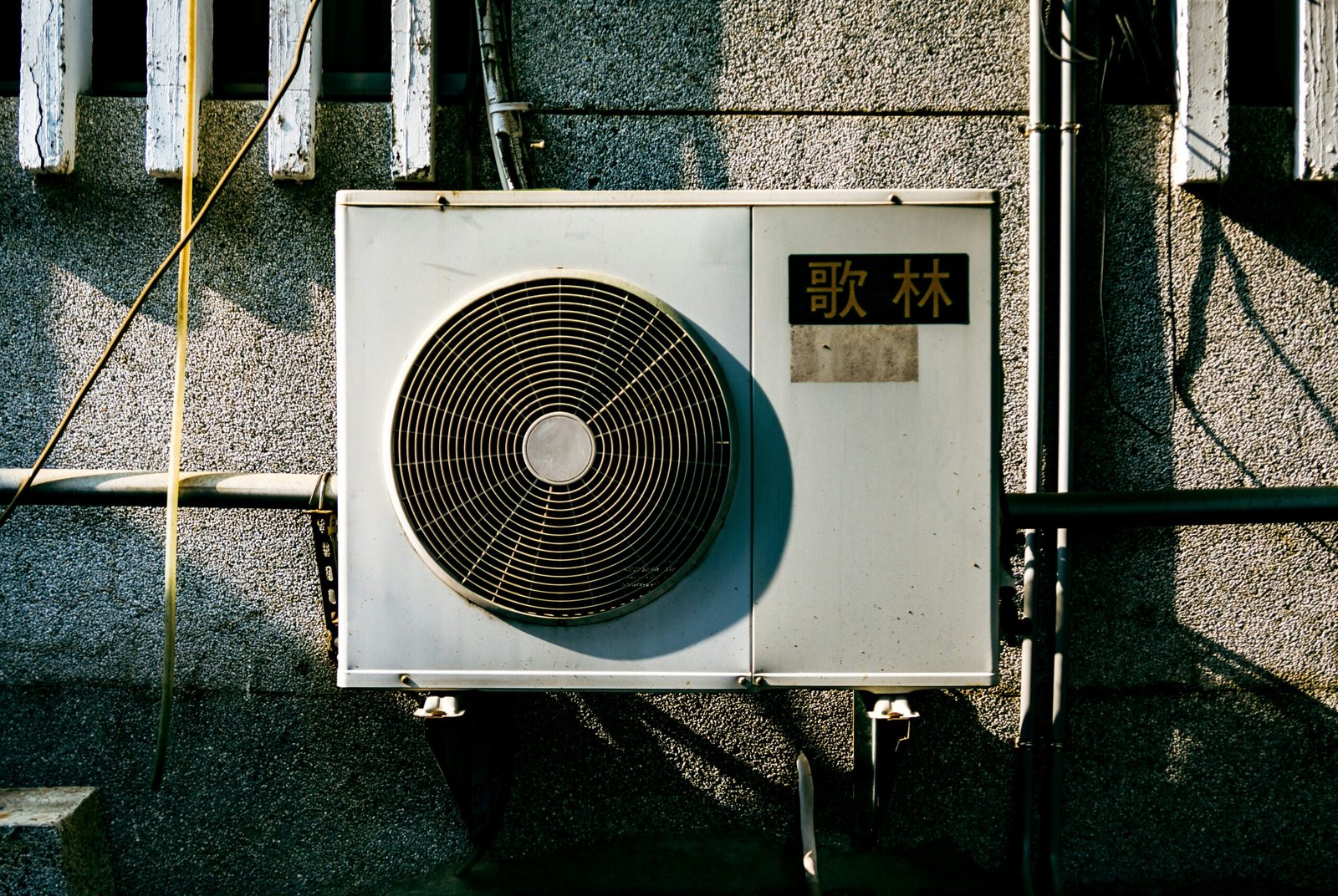 a wall mounted air conditioner mounted on the side of a building